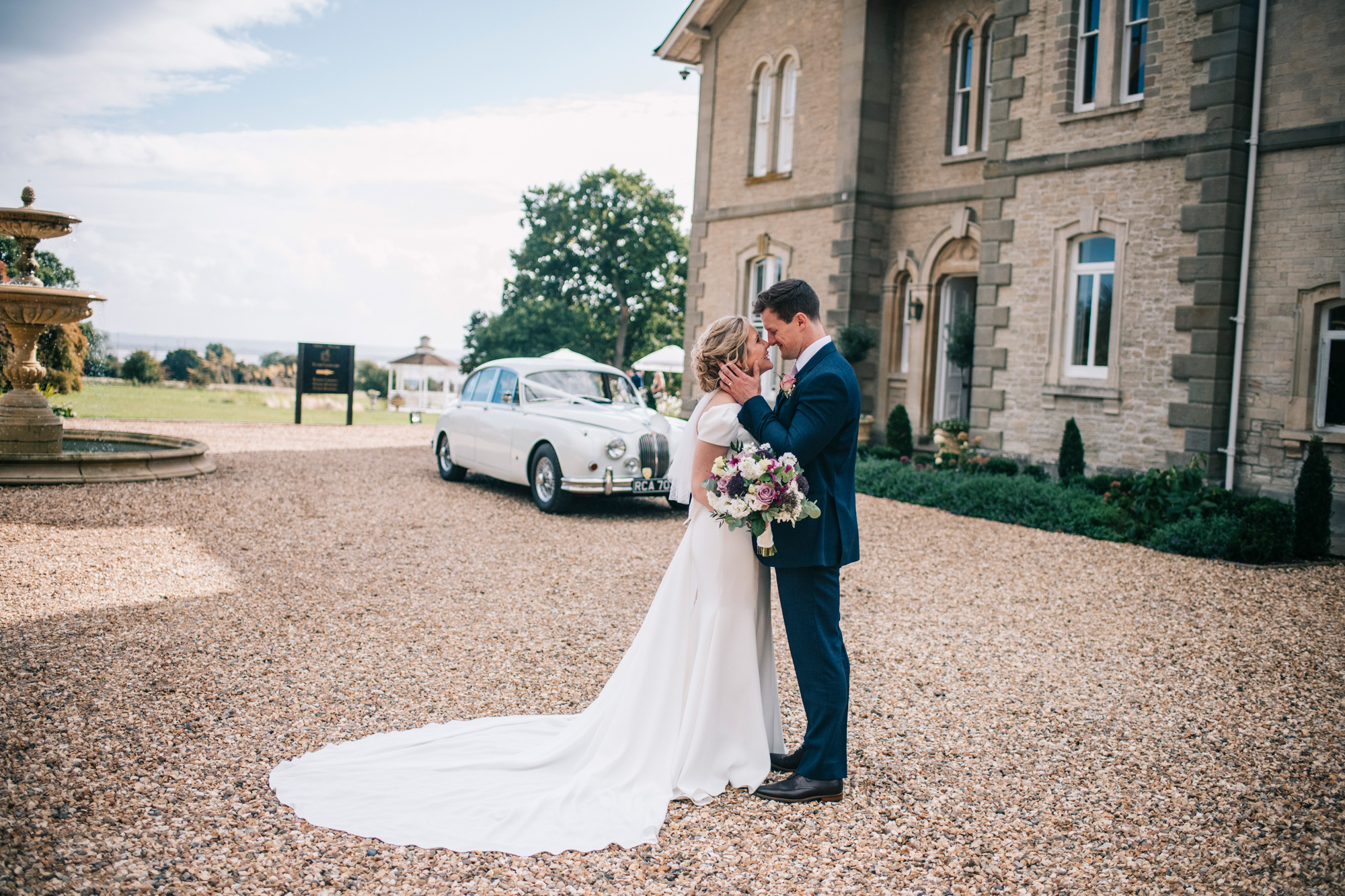 An embracing married couple outside St Tewdrics