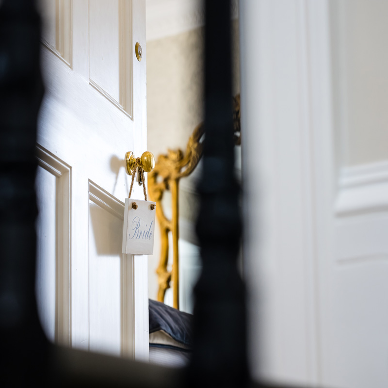 A sign saying 'Bride' hanging from a door handle